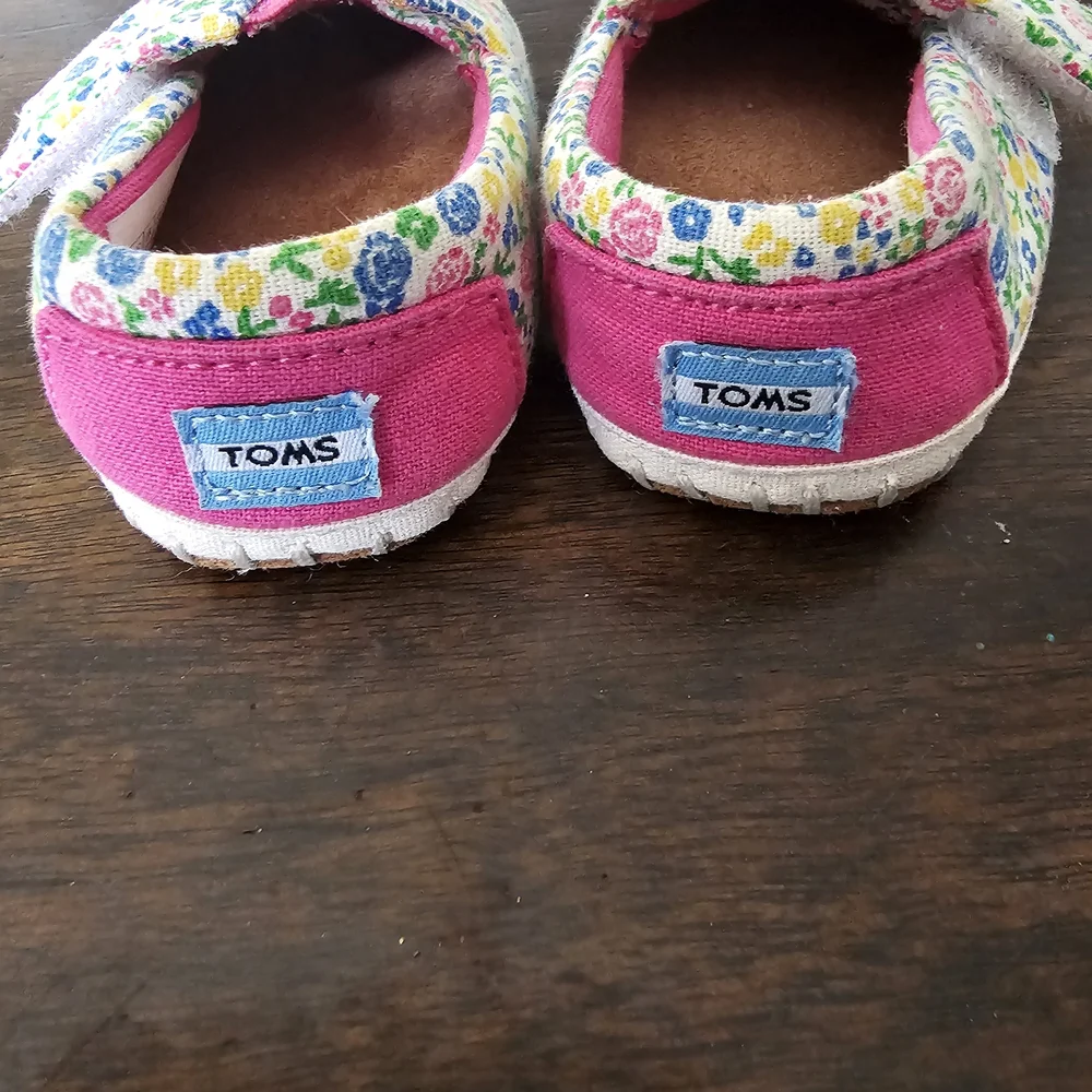 3 pairs of baby/girl shoes—soft, floral, and glittery—in various styles.